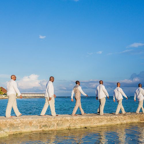 Groomsmen walking Beatles style at El Dorado Seaside Suites