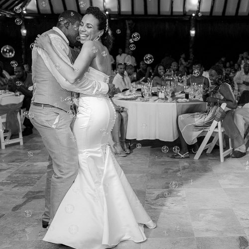 Bride dancing with groom at El Dorado Seaside Suites wedding reception