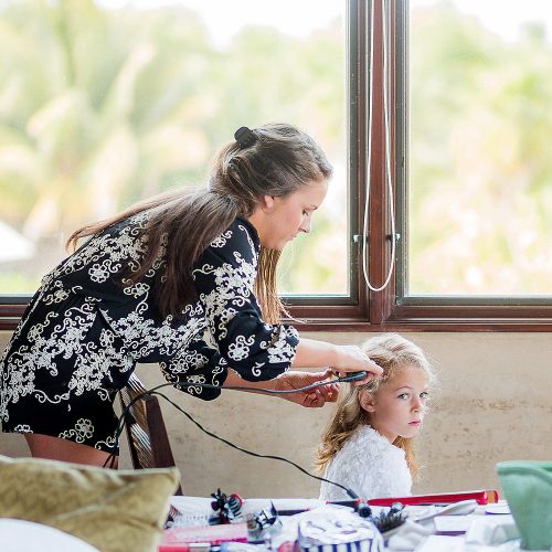 Flower girl having her hair done in Tulum