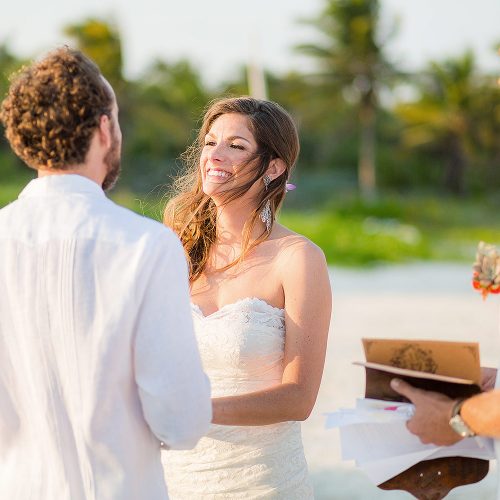 Bride and groom during ceremony at Tulum wedding