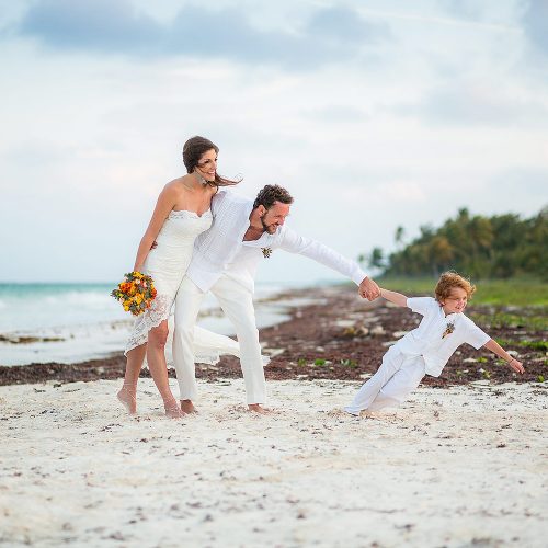 Bride and groom with their son after wedding in Tulum