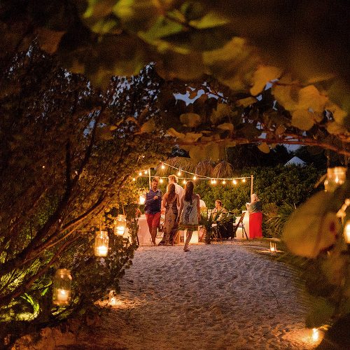 Candle lit walk way to wedding reception location in Tulum