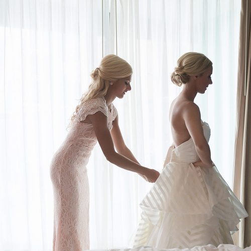Bride getting her dress zipped at Hard Rock Cancun Wedding