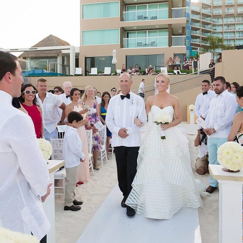Father of the brie walking her down the aisle at Hard Rock Cancun beach wedding