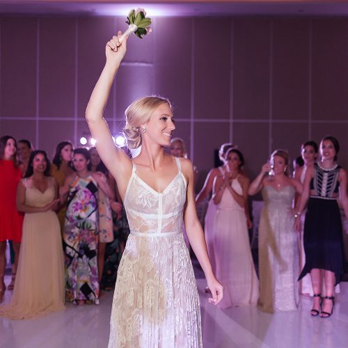 Bouquet tossing at Hard Rock Cancun wedding reception