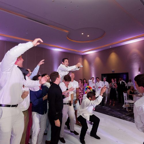 Groomsmen having fun at Hard Rock Cancun wedding reception