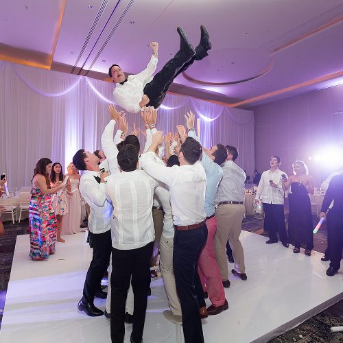 Groom being tossed at Hard Rock Cancun Wedding Reception