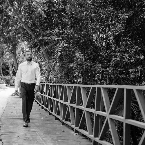 Groom walking to wedding ceremony at Azul Fives Hotel, Riviera Maya