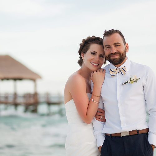 Fun photograph of bride and groom on beach at Azul Fives Hotel, Riviera Maya