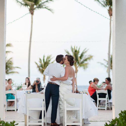 Bride and groom kissing at wedding reception at Azul Fives Hotel, Riviera Maya