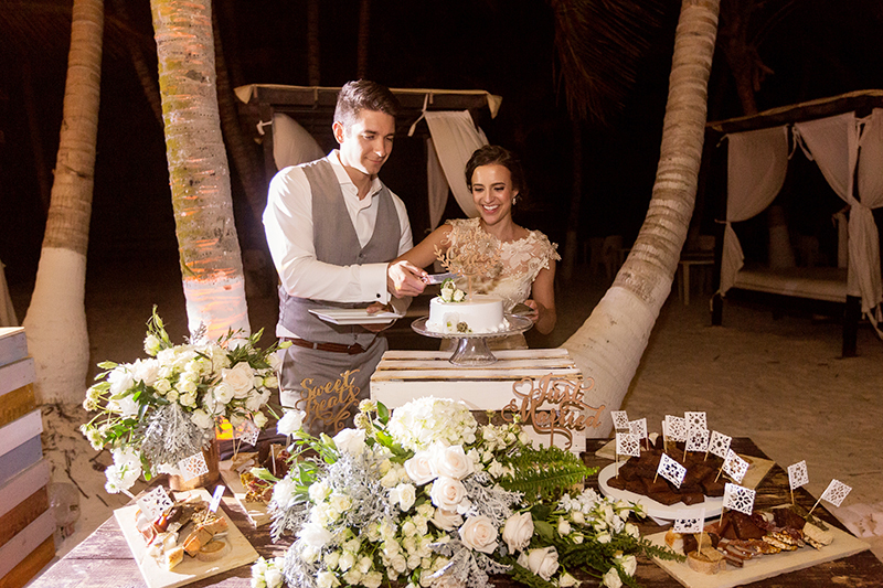 Bride and groom cutting cake at wedding