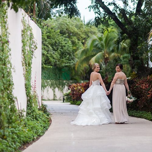 Bride and bridesmaid before wedding on walkway at Azul Fives Hotel, Riviera Maya