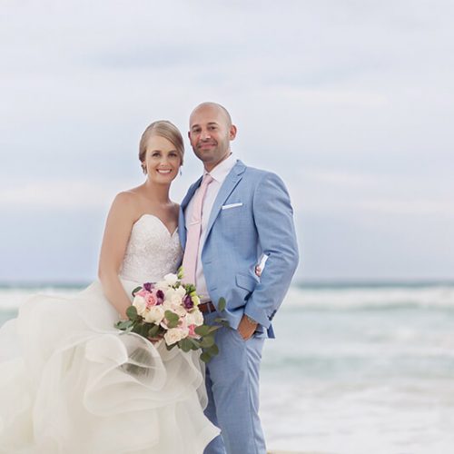 Portrait of bride and groom on beach in Riviera Maya