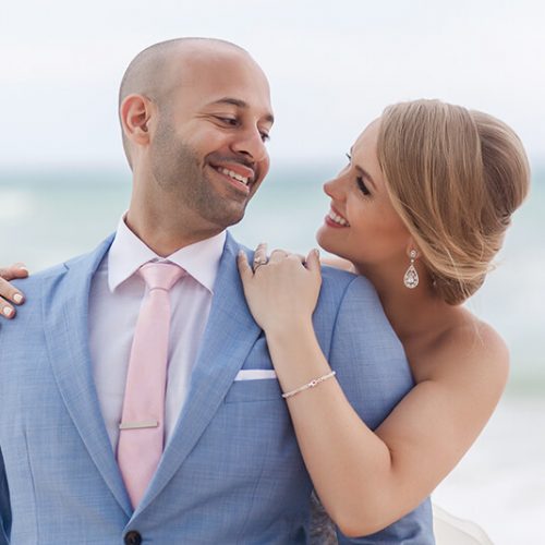 Bride and groom on beach in Riviera Maya, laughing