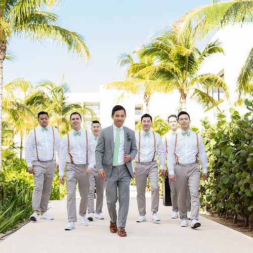 Groomsmen walking down path at Finest Playa Mujeres Resort Cancun
