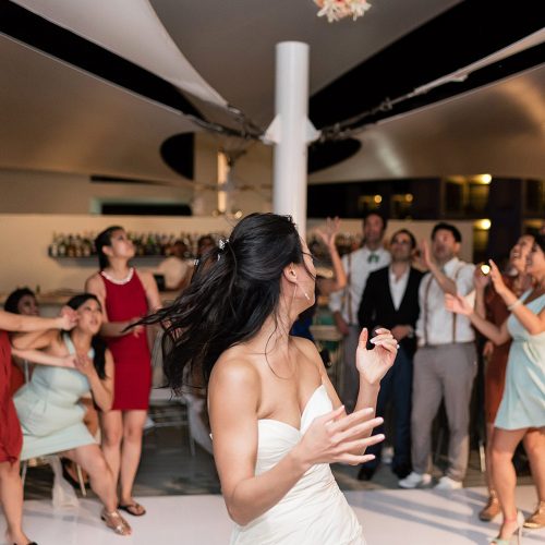 Bride tossing bouquet at Finest Playa Mujeres Resort