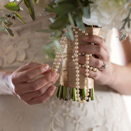 Close up of bouquet and pearls at wedding in Tulum