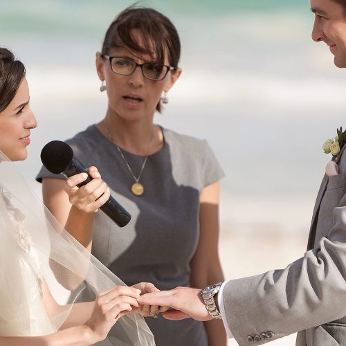 Bride giving groom ring at wedding in Tulum