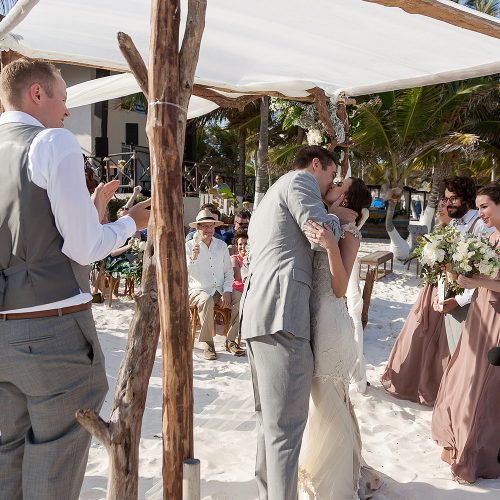 Bride and grooms first kiss at Tulum wedding