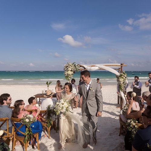 Bride and groom walking down aisle after wedding at el Paraiso Tulum