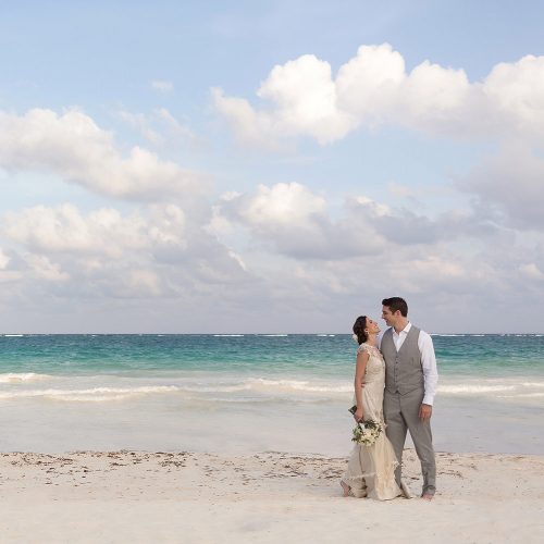 Bride and groom on beach in Tulum.