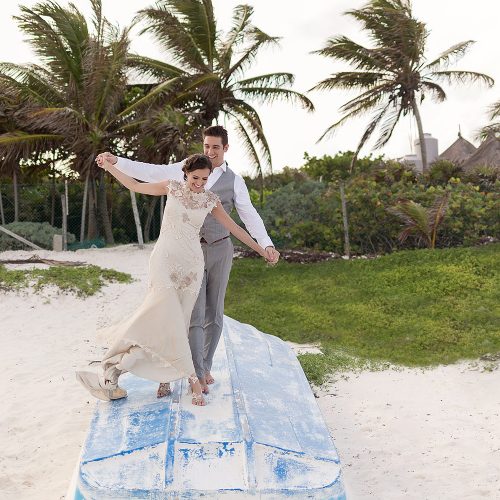 Bride and groom having fun on boat in Tulum