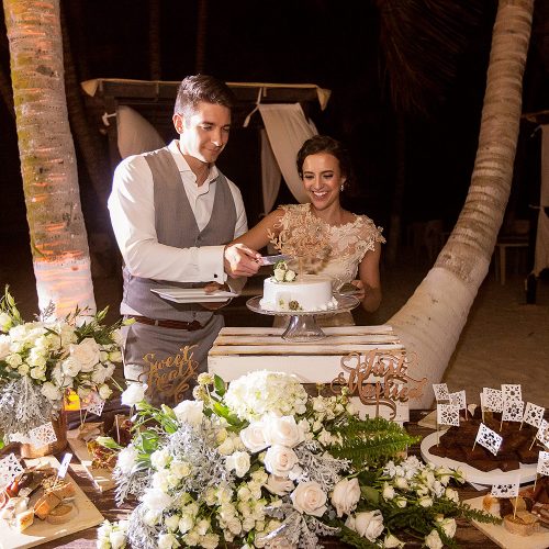 Bride and groom cutting cake at wedding in Tulum
