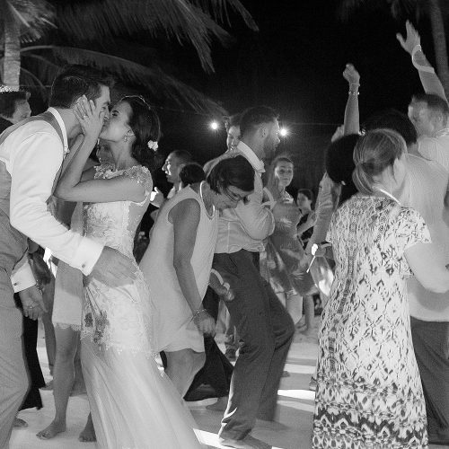 Bride and groom kissing on dance floor at Tulum wedding