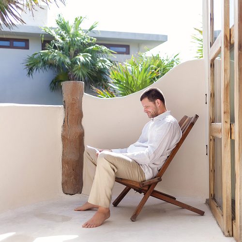 Groom reading before wedding in Tulum