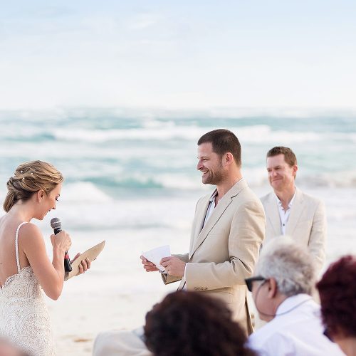 Bride and groom giving vows at beach wedding in Tulum