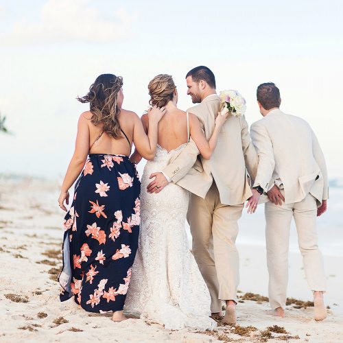Bridal party walking on beach in Tulum