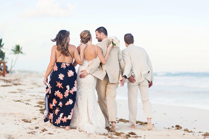 Bridal party walking on beach in Tulum