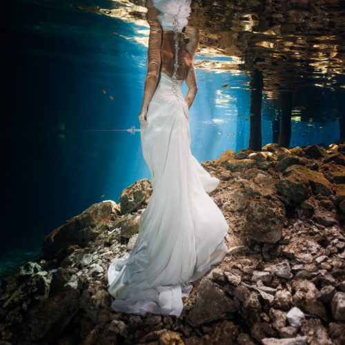 Half bride dress underwater at trash the dress in Mayan Cenote Riviera Maya