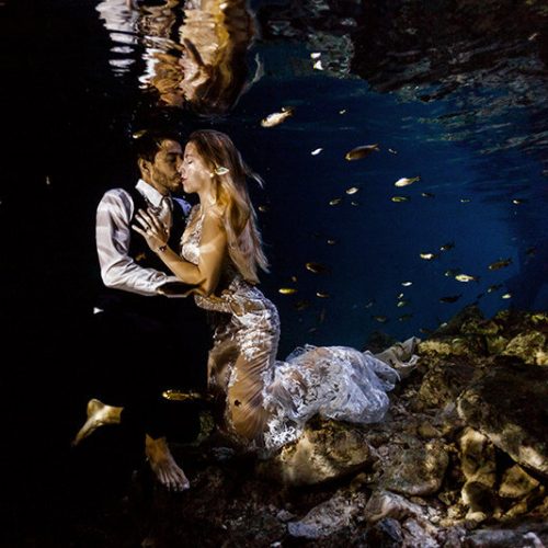 Couple about to kiss in underwater photo shoot in Maya Cenote