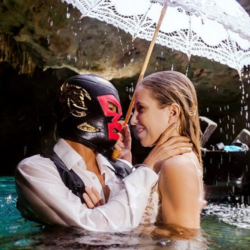 Groom wearing a mask in photoshoot on a Maya cenote