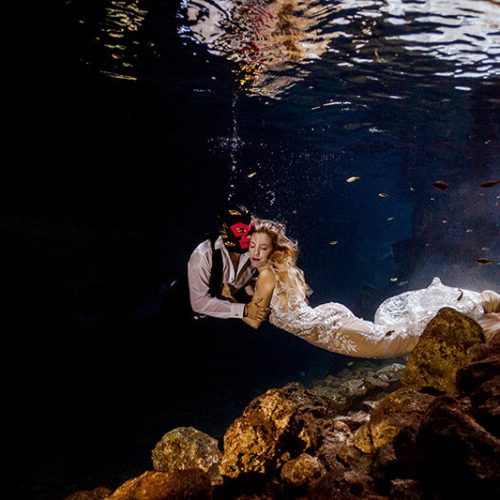 Bride and groom in fun underwater photo shoot at Maya Cenote