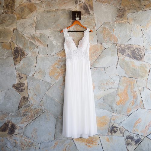 Wedding dress hanging on rock wall in Riviera Maya
