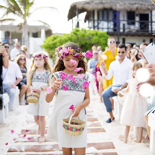 Flower girl throwing flowers at Riviera Maya wedding