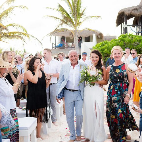Bride walking down beach aisle at wedding in Rivera Maya