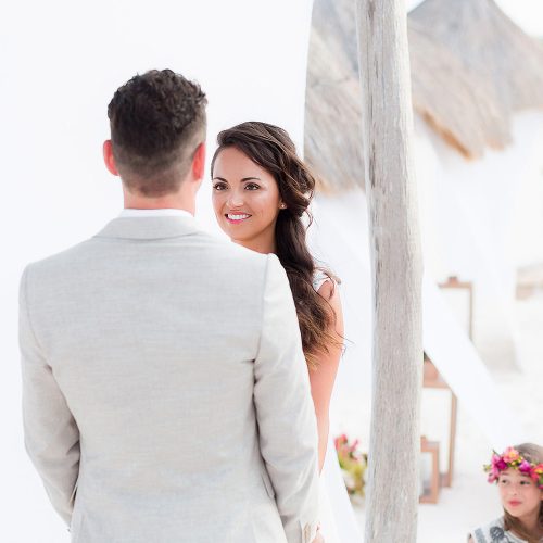 Bride and groom giving vows at beach wedding