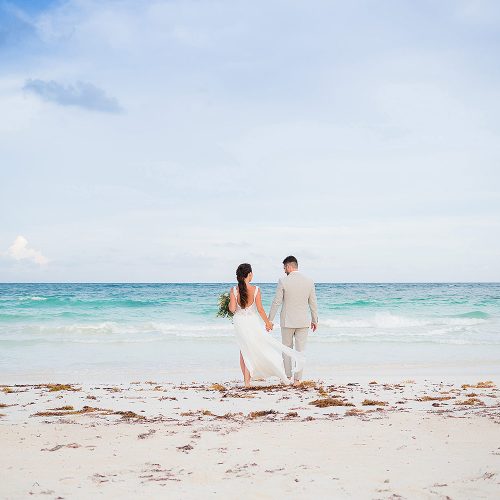 Bride and groom on beach after wedding ceremony