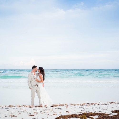 Bride and groom on beach after wedding