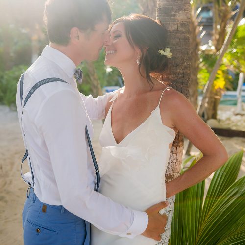 Romantic photograph of bride and groom in garden in Tulum