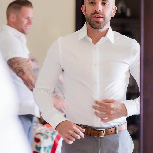 Groom looking in mirror getting ready at NOW Jade Riviera Cancun