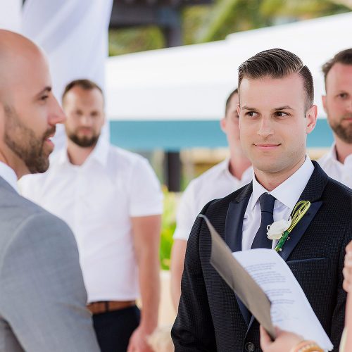 Grooms saying vows at gay wedding at pergola wedding ceremony location