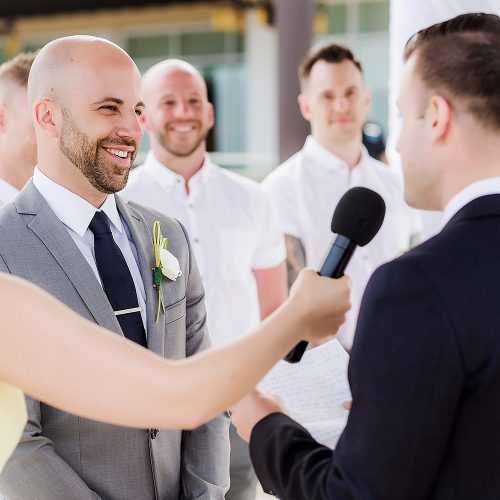 Grooms saying vows at gay wedding