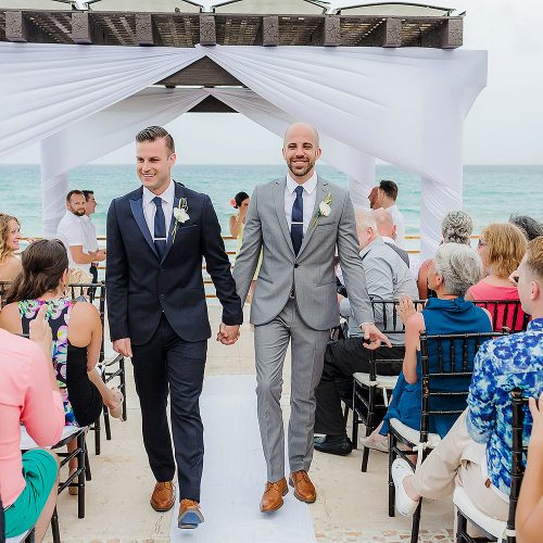 Grooms walking after wedding ceremony at NOW Jade Riviera Cancun resort
