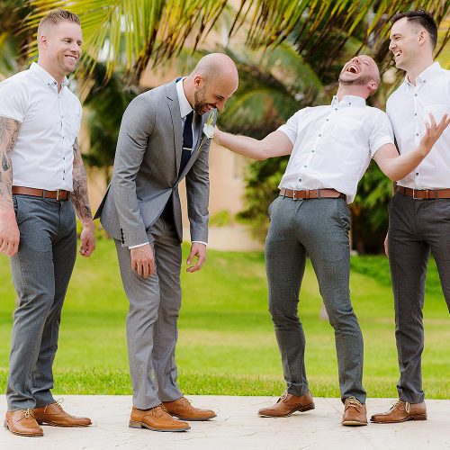 Fun photograph of groom with groomsmen