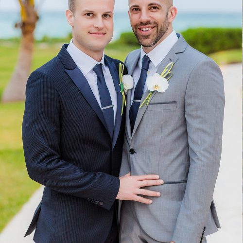 Grooms together after day wedding in garden at NOW Jade Riviera Cancun resort