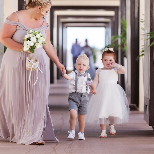 Ring bearer and flower girl walking down aisle at Royalton Riviera Cancun Wedding